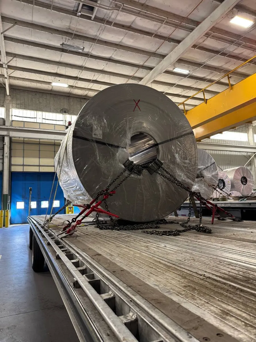 Aluminum coil chained down on a flatbed
