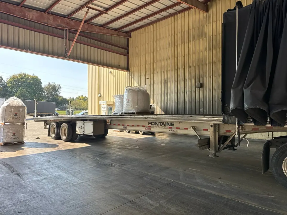 Conestoga trailer opened under a loading canopy